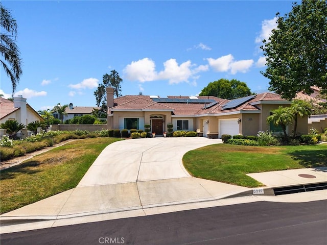 5914 Johnston Pl, Rancho Cucamonga, CA 91739 - view of front of house with stucco siding, a front yard, a garage, solar panels, and concrete driveway
