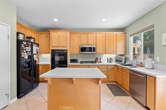 11868 Bunker Hill Dr, Rancho Cucamonga, CA 91730 - kitchen with black appliances, a kitchen island, light tile patterned floors, light brown cabinetry, and light countertops