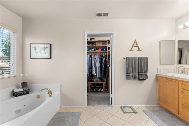 11868 Bunker Hill Dr, Rancho Cucamonga, CA 91730 - bathroom with vanity, a tub with jets, tile patterned flooring, and a spacious closet