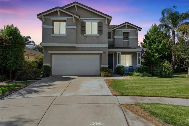 11868 Bunker Hill Dr, Rancho Cucamonga, CA 91730 - view of front of house with stucco siding, driveway, a lawn, and an attached garage