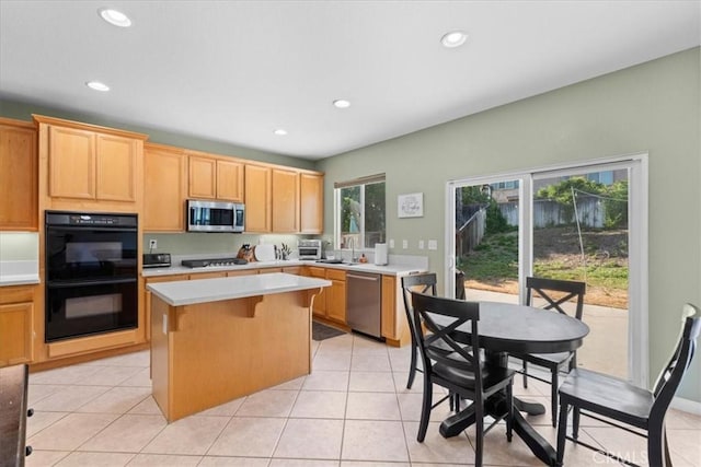 11868 Bunker Hill Dr, Rancho Cucamonga, CA 91730 - kitchen featuring stainless steel appliances, a kitchen island, light countertops, recessed lighting, and light tile patterned floors