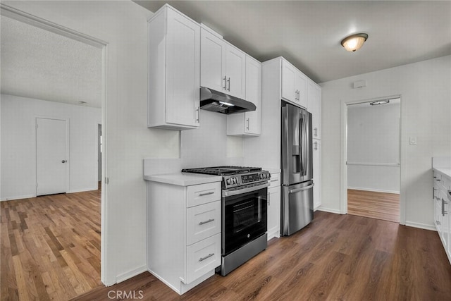 1014 W 185th St, Gardena, CA 90248 - kitchen with under cabinet range hood, appliances with stainless steel finishes, light countertops, and dark wood-style flooring