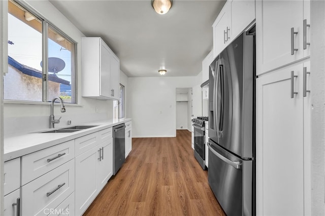 1014 W 185th St, Gardena, CA 90248 - kitchen featuring appliances with stainless steel finishes, white cabinetry, light countertops, and light wood finished floors
