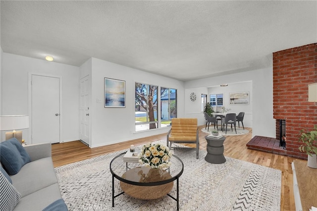 1014 W 185th St, Gardena, CA 90248 - living area featuring a textured ceiling, wood finished floors, and a fireplace