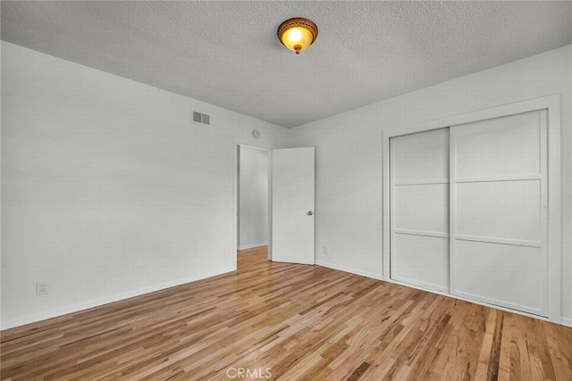 1014 W 185th St, Gardena, CA 90248 - unfurnished bedroom with light wood-type flooring, a closet, and a textured ceiling