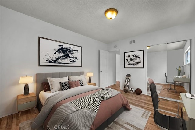 1014 W 185th St, Gardena, CA 90248 - bedroom with a textured ceiling, light wood finished floors, and a closet