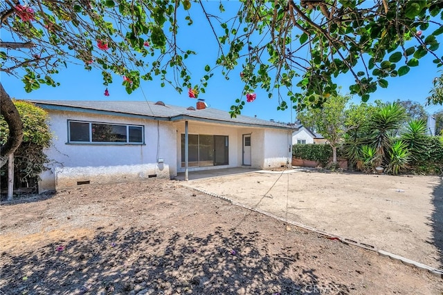 1014 W 185th St, Gardena, CA 90248 - rear view of house with stucco siding, a patio, and crawl space