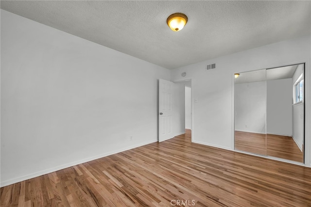 1014 W 185th St, Gardena, CA 90248 - unfurnished bedroom featuring wood finished floors, a textured ceiling, and a closet