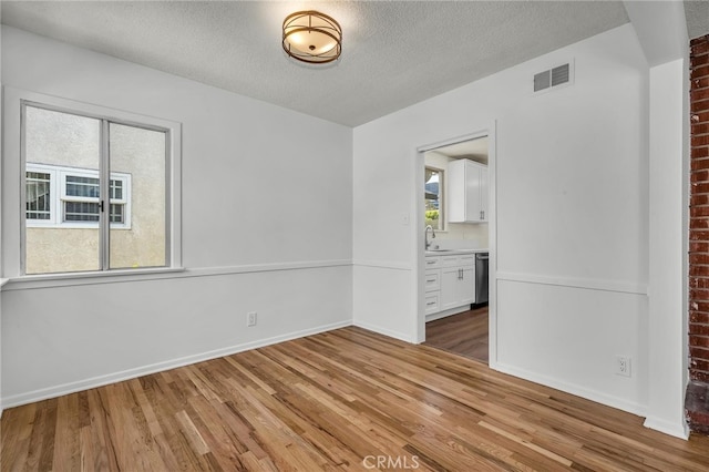 1014 W 185th St, Gardena, CA 90248 - unfurnished room with wood finished floors and a textured ceiling