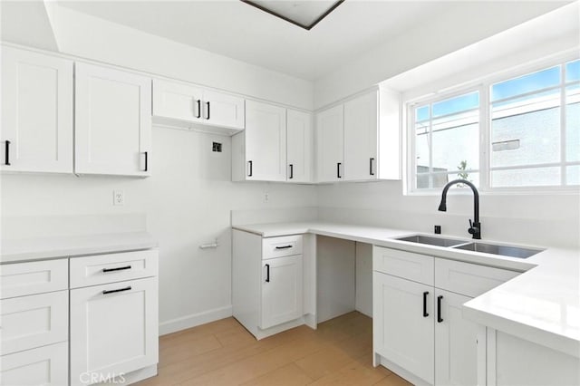 17742 Devonshire St Unit 3, Northridge, CA 91325 - kitchen featuring white cabinetry, light wood-style floors, and light countertops