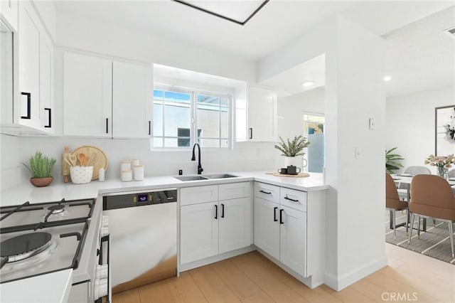 17742 Devonshire St Unit 3, Northridge, CA 91325 - kitchen with dishwasher, light countertops, white cabinetry, and recessed lighting
