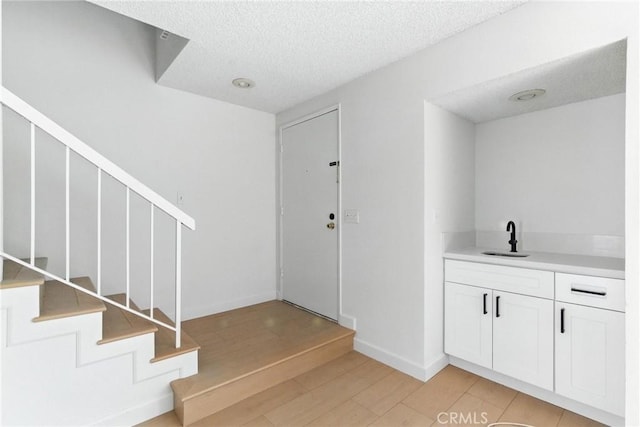 17742 Devonshire St Unit 3, Northridge, CA 91325 - interior space with stairs, a textured ceiling, and light wood finished floors