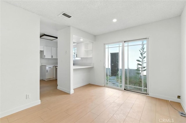 17742 Devonshire St Unit 3, Northridge, CA 91325 - unfurnished room featuring light wood-style floors, a textured ceiling, and recessed lighting