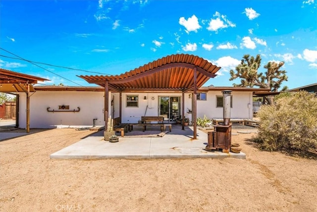 7638 Dumosa Ave, Yucca Valley, CA 92284 - rear view of house featuring a tile roof, a patio, and stucco siding