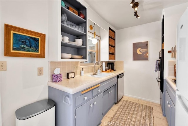 7638 Dumosa Ave, Yucca Valley, CA 92284 - kitchen with stainless steel dishwasher, decorative backsplash, gray cabinets, open shelves, and light tile patterned flooring