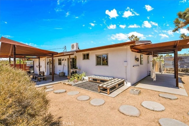 7638 Dumosa Ave, Yucca Valley, CA 92284 - rear view of property featuring a patio area and stucco siding