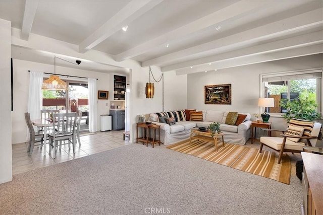 7638 Dumosa Ave, Yucca Valley, CA 92284 - living room featuring beam ceiling, light tile patterned flooring, and light colored carpet