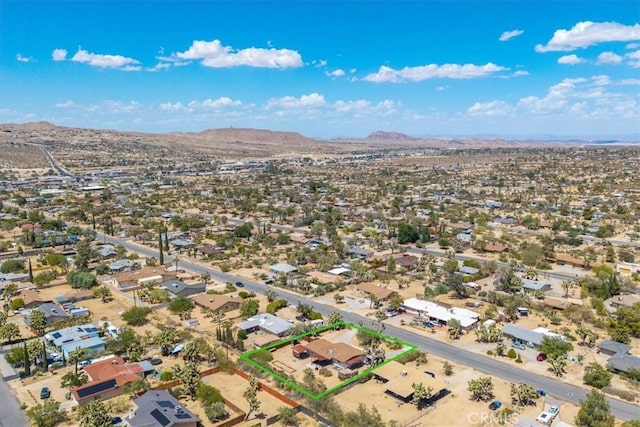 7638 Dumosa Ave, Yucca Valley, CA 92284 - aerial overview of property's location with a mountainous background and property parcel outlined