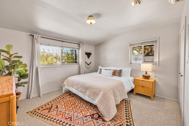 7638 Dumosa Ave, Yucca Valley, CA 92284 - bedroom featuring multiple windows, light carpet, and lofted ceiling