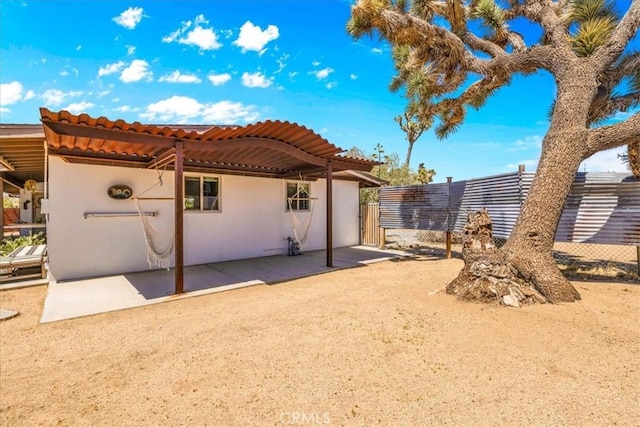 7638 Dumosa Ave, Yucca Valley, CA 92284 - rear view of property featuring stucco siding, a patio area, and a tiled roof