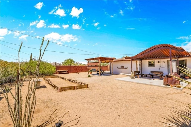 7638 Dumosa Ave, Yucca Valley, CA 92284 - view of yard featuring a game area and a pergola