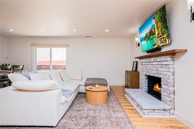9140 Garden St, Rancho Cucamonga, CA 91701 - living area with a brick fireplace, wood finished floors, and recessed lighting