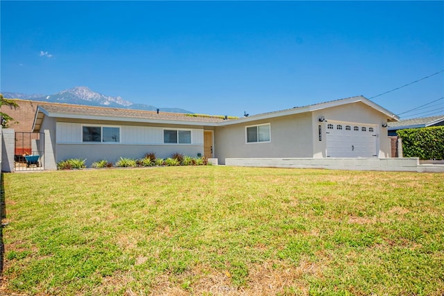 9140 Garden St, Rancho Cucamonga, CA 91701 - ranch-style house featuring a garage, a front yard, a mountain view, and stucco siding