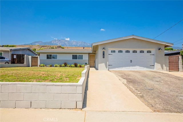 9140 Garden St, Rancho Cucamonga, CA 91701 - ranch-style home with asphalt driveway, a garage, stucco siding, and a mountain view