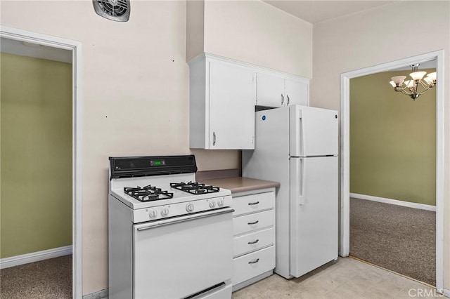 2344 Porter Way, Chico, CA 95926 - kitchen with white appliances, white cabinets, a chandelier, and light countertops