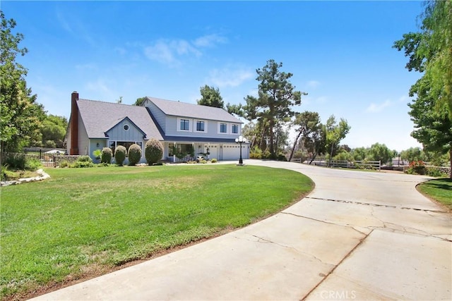 17321 Sunset View Dr, Riverside, CA 92504 - view of front of property with an attached garage, curved driveway, a front lawn, and a chimney