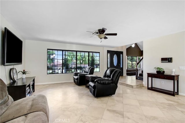 17321 Sunset View Dr, Riverside, CA 92504 - living room with light tile patterned floors, stairway, and a ceiling fan