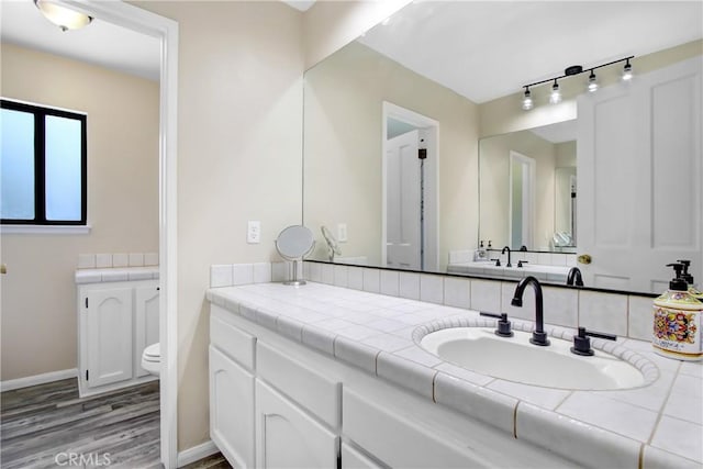 17321 Sunset View Dr, Riverside, CA 92504 - bathroom featuring wood finished floors and vanity