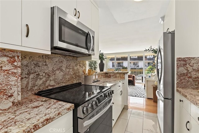 6542 Ocean Crest Dr Unit B208, Rancho Palos Verdes, CA 90275 - kitchen with stainless steel appliances, white cabinetry, and light stone countertops