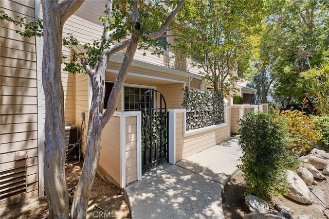 7038 De Celis Pl Unit 4, Van Nuys, CA 91406 - view of side of home with a gate and a central air condition unit
