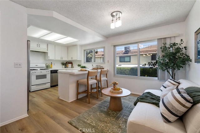 7038 De Celis Pl Unit 4, Van Nuys, CA 91406 - kitchen featuring white range with gas stovetop, stainless steel dishwasher, healthy amount of natural light, light countertops, and a textured ceiling