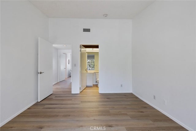 7038 De Celis Pl Unit 4, Van Nuys, CA 91406 - empty room with light wood-style floors and a smoke detector