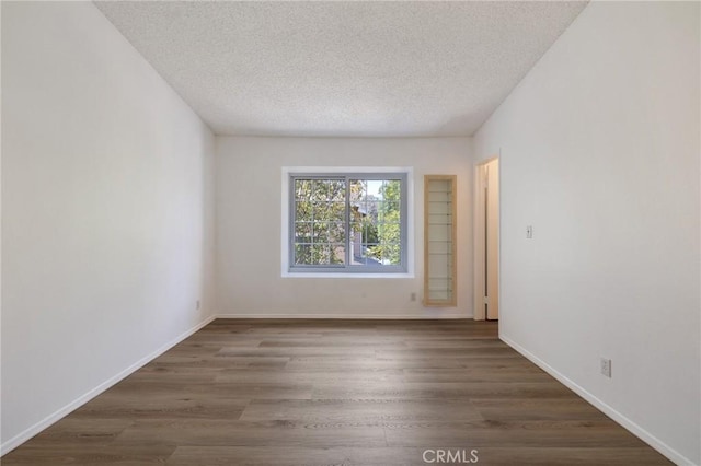 7038 De Celis Pl Unit 4, Van Nuys, CA 91406 - spare room featuring a textured ceiling and wood finished floors