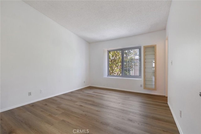 7038 De Celis Pl Unit 4, Van Nuys, CA 91406 - empty room with a textured ceiling and wood finished floors