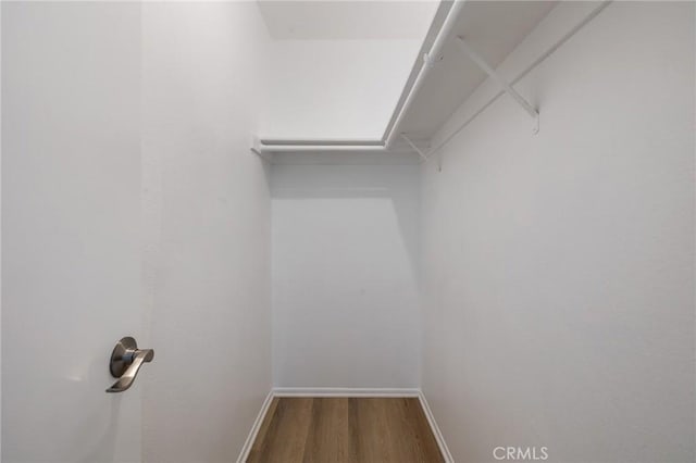 7038 De Celis Pl Unit 4, Van Nuys, CA 91406 - walk in closet featuring wood finished floors