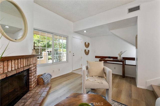 7038 De Celis Pl Unit 4, Van Nuys, CA 91406 - living area with wood finished floors, a fireplace, lofted ceiling, and recessed lighting