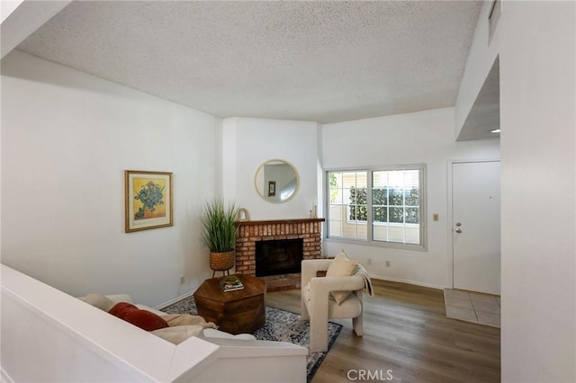7038 De Celis Pl Unit 4, Van Nuys, CA 91406 - living room with a textured ceiling, wood finished floors, and a brick fireplace