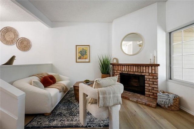 7038 De Celis Pl Unit 4, Van Nuys, CA 91406 - living area with wood finished floors and a brick fireplace