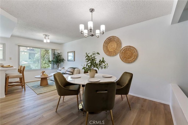 7038 De Celis Pl Unit 4, Van Nuys, CA 91406 - dining area with a textured ceiling, wood finished floors, and a chandelier