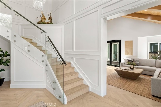 19022 Shamrock Ln, Yorba Linda, CA 92886 - staircase featuring a decorative wall, high vaulted ceiling, and a chandelier