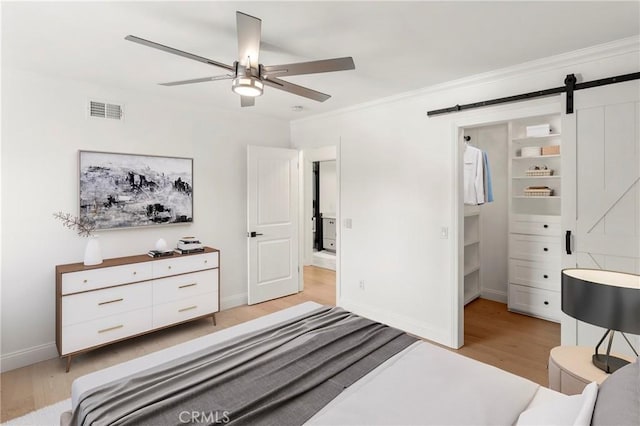 19022 Shamrock Ln, Yorba Linda, CA 92886 - bedroom with light wood finished floors, a barn door, ornamental molding, and ceiling fan