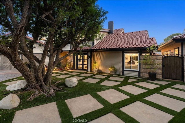19022 Shamrock Ln, Yorba Linda, CA 92886 - back of property with french doors, a tile roof, a gate, a chimney, and a patio