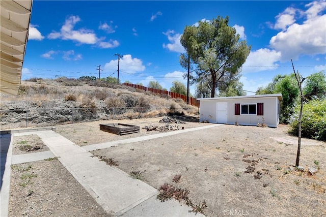 28296 Oregon Pl, Menifee, CA 92587 - view of yard featuring an outbuilding and a vegetable garden