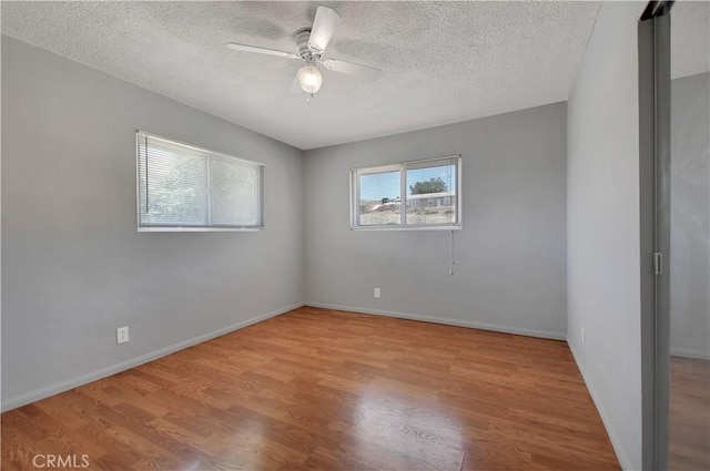 28296 Oregon Pl, Menifee, CA 92587 - empty room with wood finished floors, a textured ceiling, and a ceiling fan