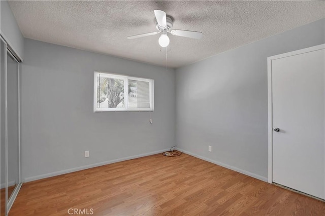 28296 Oregon Pl, Menifee, CA 92587 - unfurnished bedroom featuring light wood finished floors, a textured ceiling, a closet, and a ceiling fan