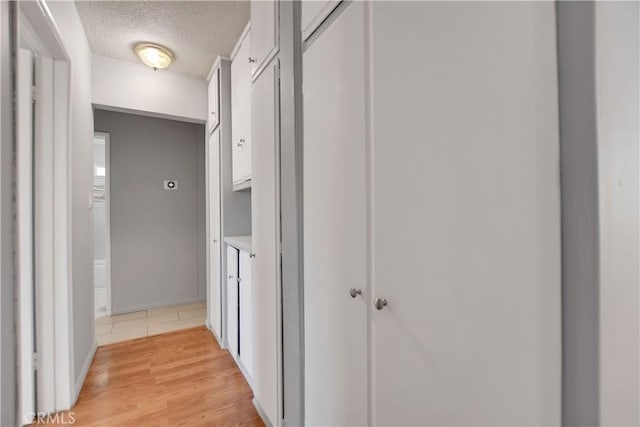 28296 Oregon Pl, Menifee, CA 92587 - corridor featuring a textured ceiling and light wood-type flooring